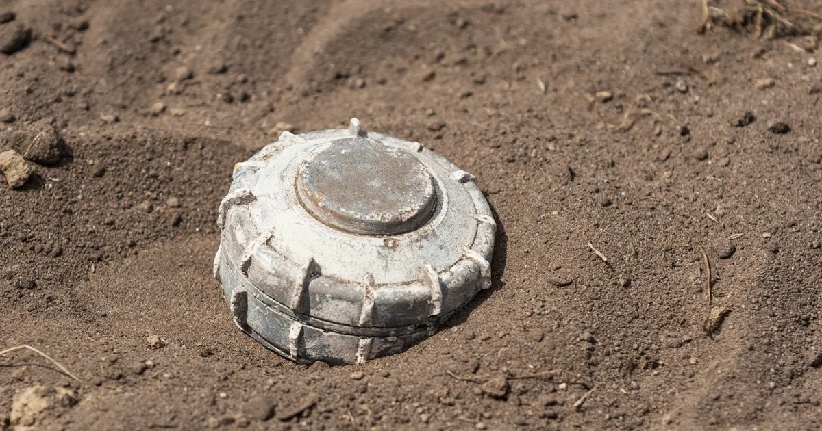 Landmine lying uncovered in dirt